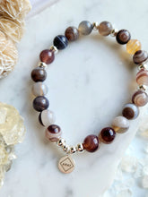 Load image into Gallery viewer, Agate&#39;s captivating swirls and bands harmonize energies, promoting balance and tranquility. Embrace its calming presence in meditation, letting its gentle vibrations cleanse your mind and spirit, leading you to inner peace. Each agate piece showcases Earth&#39;s artistic prowess, offering not only beauty but also a connection to higher spiritual realms
