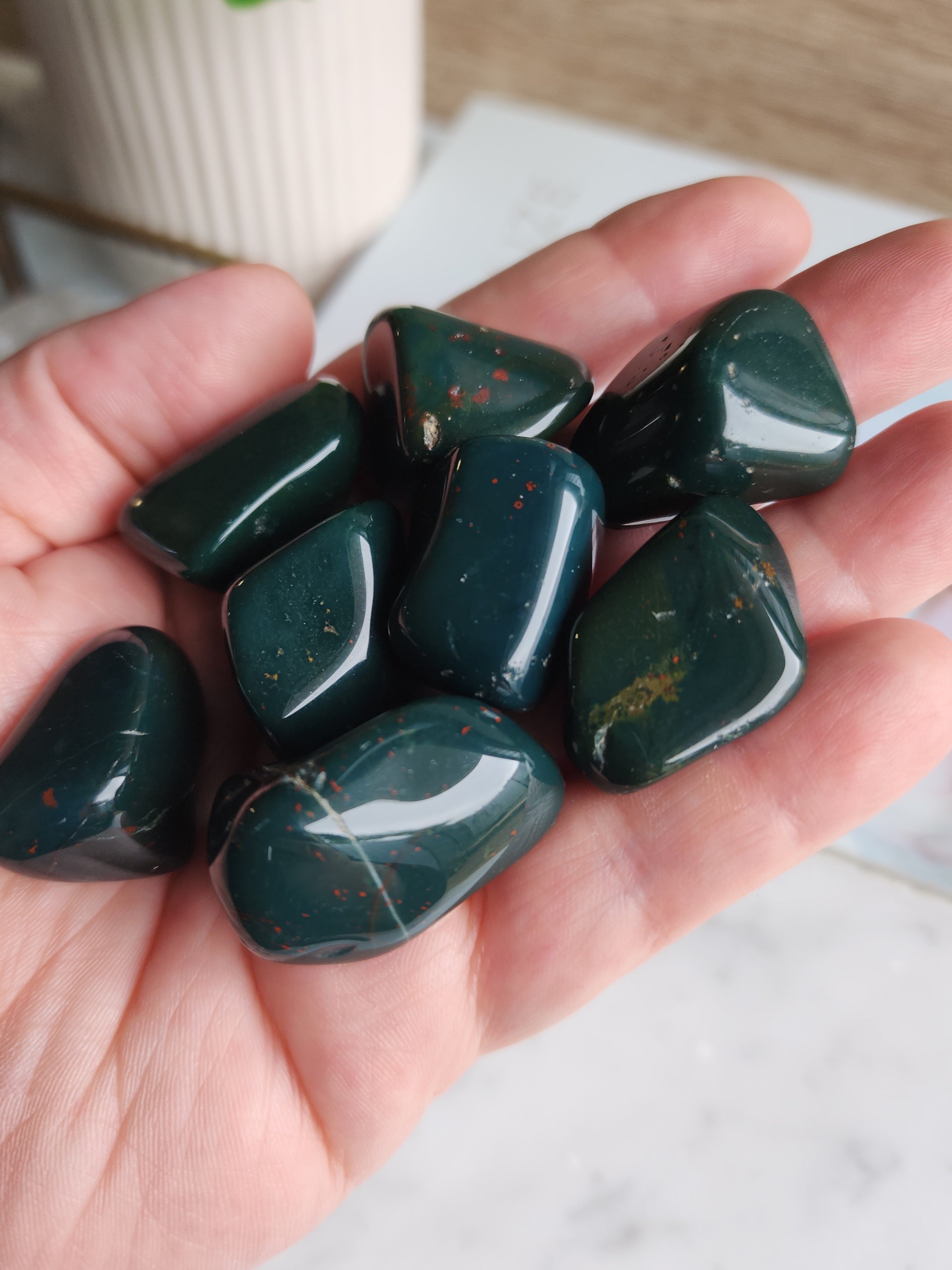 Polished Bloodstone tumble stone featuring deep green chalcedony with natural red hematite spots.