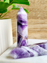 Load image into Gallery viewer, Chevron Amethyst, a captivating blend of amethyst and white quartz, offers profound spiritual benefits, promoting inner peace and personal growth
