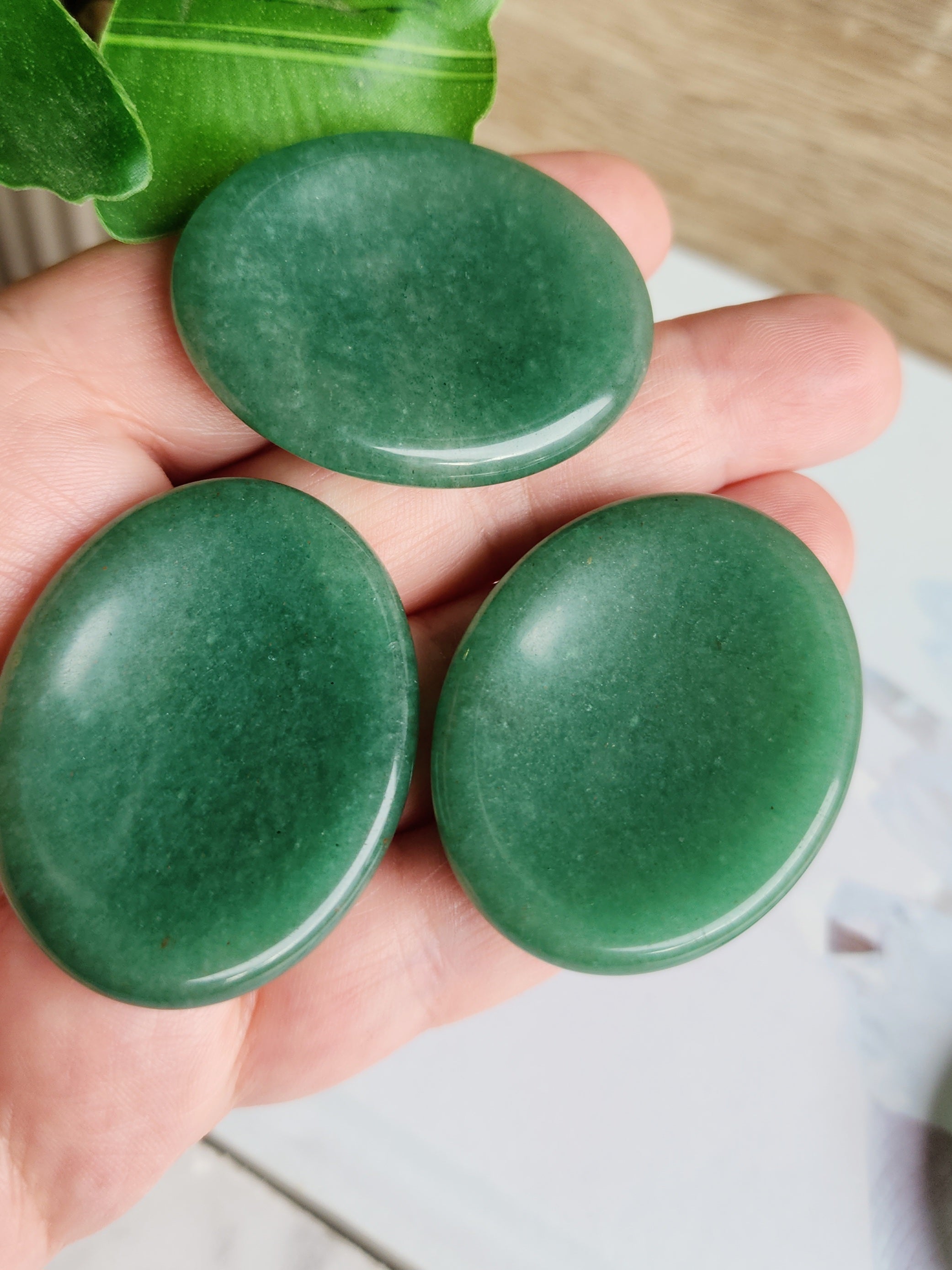 Polished Green Aventurine worry stone featuring natural green colouring and a thumb-sized indentation.