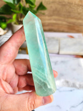 Load image into Gallery viewer, Stay focused with Green Fluorite. Its calming energy and vibrant beauty help you stay organized and achieve your goals, whether you&#39;re studying or tackling new projects
