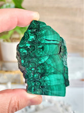 Load image into Gallery viewer, Malachite is believed to possess powerful spiritual properties that can aid in emotional healing, transformation, and protection, while also enhancing intuition and promoting spiritual growth.
