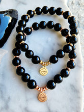Load image into Gallery viewer, Black Obsidian is a powerful protector, grounding you to the earth while shielding against negativity and purifying your surroundings for a balanced energy flow.
