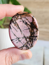 Load image into Gallery viewer, Experience the transformative essence of Rhodonite, a potent healer fostering unconditional love and deep emotional healing. This gemstone encourages self-compassion, empathy, and an open heart, guiding you on a profound spiritual journey of love and understanding
