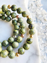 Load image into Gallery viewer, Snakeskin Jasper, a unique form of serpentine, is a powerful stone for grounding, protection, and transformation. Its calming energy helps you embrace change, foster inner peace, and shield against negativity
