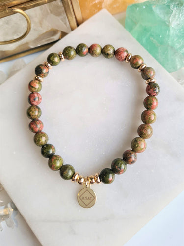 Unakite is a nurturing stone that promotes unity and helps to strengthen relationships and the bonds between parent and child